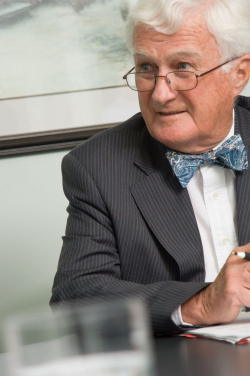 Corporate Photograph of bow-tied man in his late sixities, invol