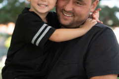 Casual Portrait of a father holding his young son, both dressed