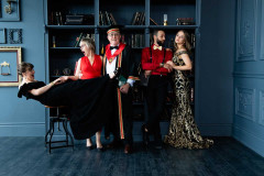 Studio Family Portrait in formal attire playfully posed against