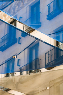 Photograph of Blue, Transluscent Sun Shade over Pedestrian stree