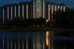 Clock at dusk at Hilton Suites and reflecton in pool of water fr