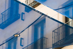 Photograph of Blue, Transluscent Sun Shade over Pedestrian stree